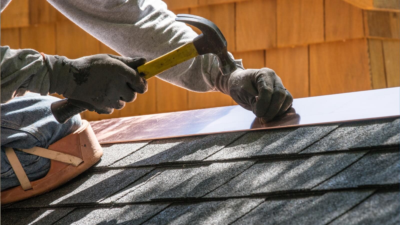 fixing a roof with hammer and nail