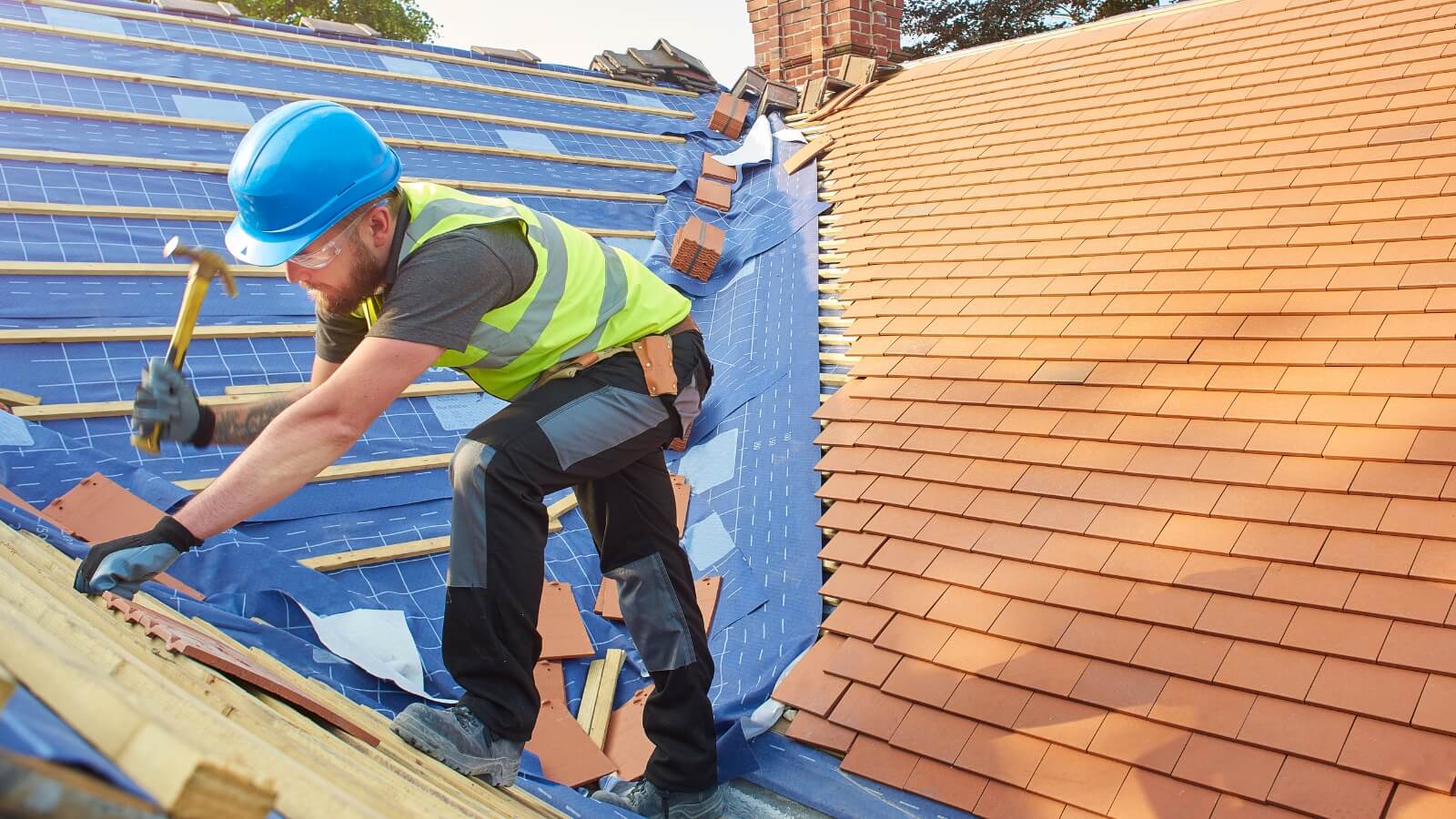 Roofer putting shingles onto roof