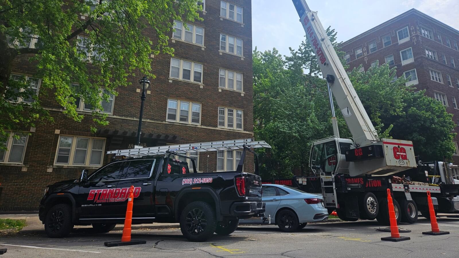 Standard roofing truck in front of building